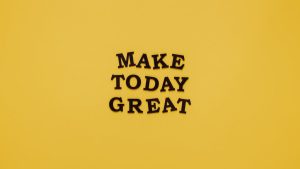 Simple and motivational quote 'Make Today Great' on a minimalist yellow background for inspiration.